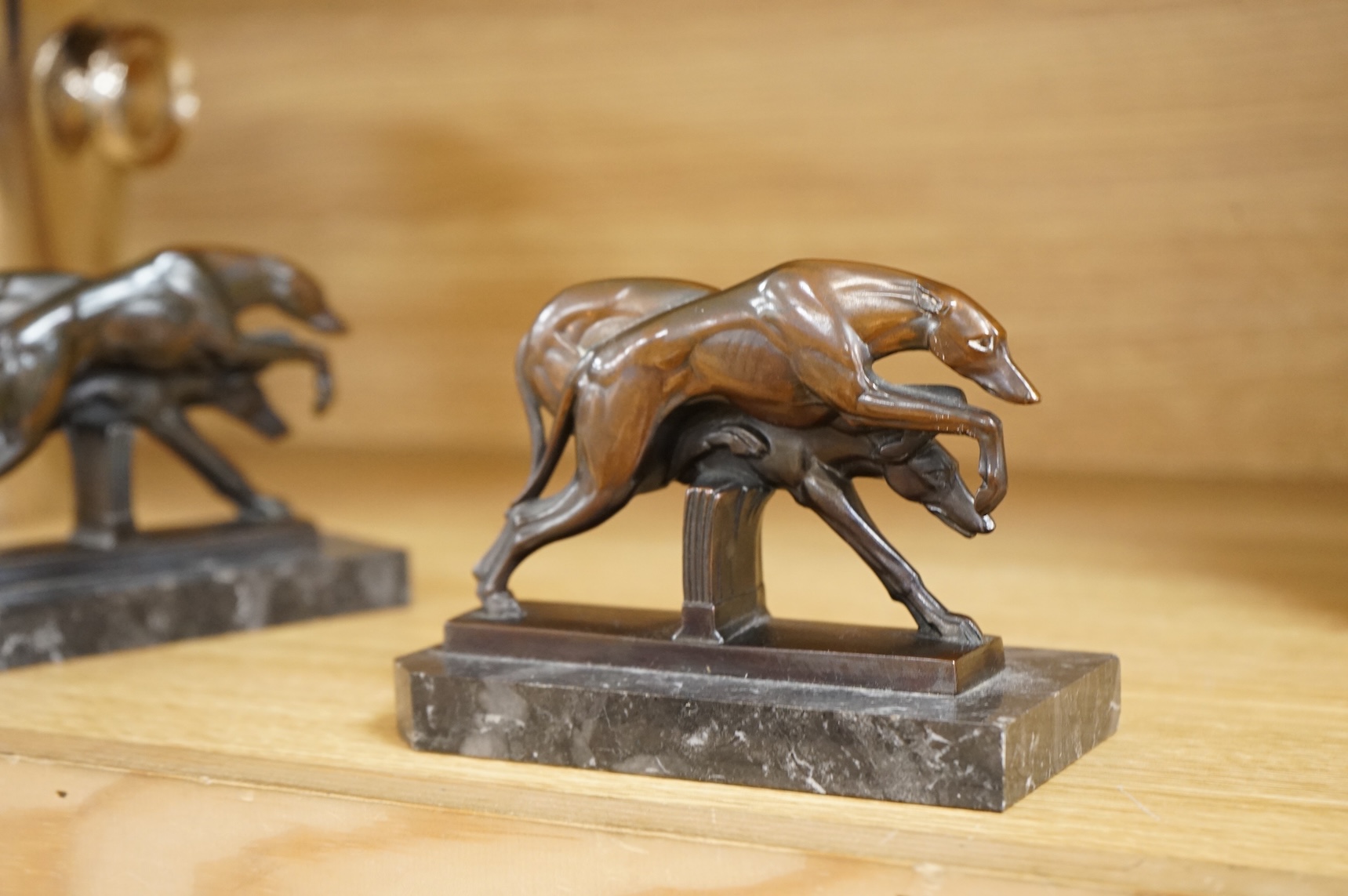A pair of French Art Deco spelter bookends in the form of racing greyhounds, 14.5cm wide